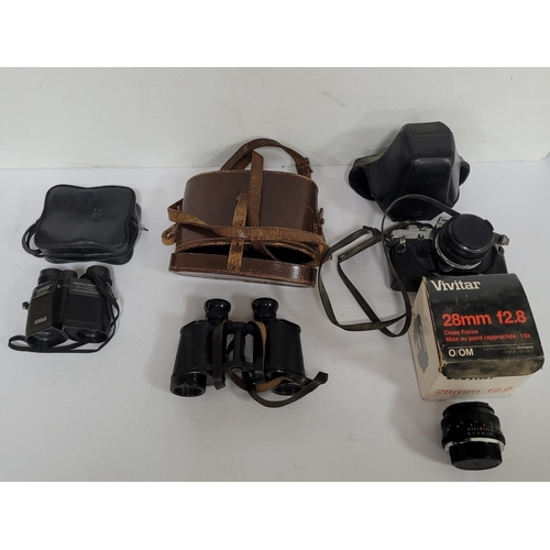 70 - Two pairs of binoculars and a camera including a new boxed lens etc