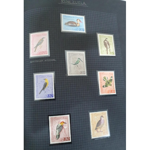 192 - 2 old black stamp albums containing a selection of MU bird stamps from around the world