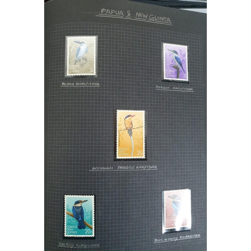 192 - 2 old black stamp albums containing a selection of MU bird stamps from around the world