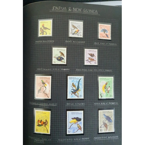 192 - 2 old black stamp albums containing a selection of MU bird stamps from around the world