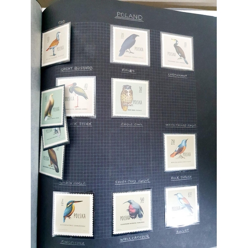 192 - 2 old black stamp albums containing a selection of MU bird stamps from around the world