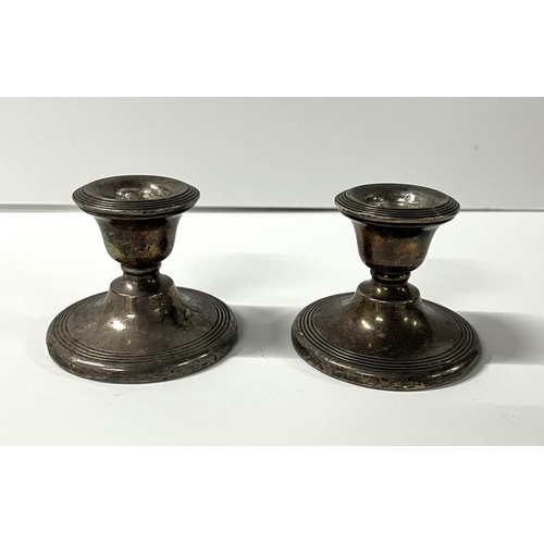 17 - Pair of dwarf silver weighted candlesticks