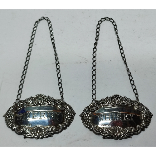 23 - Two Birmingham silver decanter labels on chains, one 