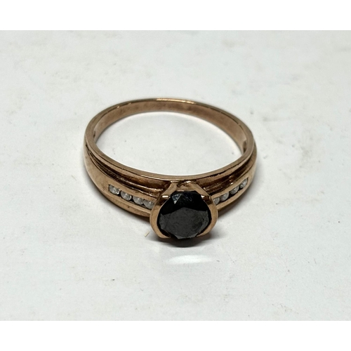 41 - Hallmarked 9ct rose gold, diamond and circular cut dark central stone ring,

3.6 grams gross        ... 