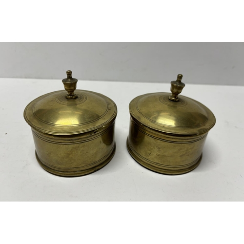 87 - Pair of antique brass inkwells, both with original glass inner bottles (2)