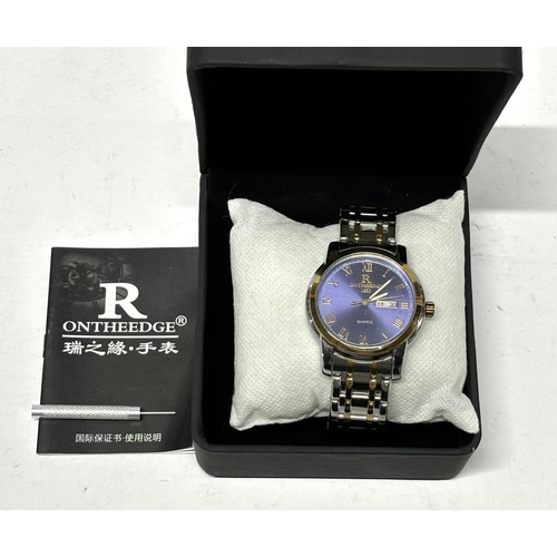 171 - ONTHEEDGE blue faced watch with papers and boxed