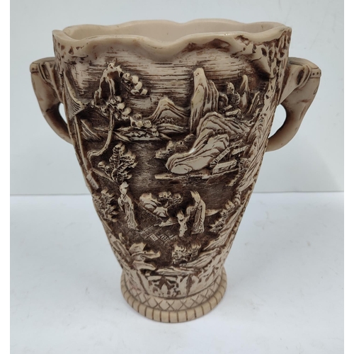 403 - Heavily carved oriental vase with landscape and figures depicted with the handles in the form of ele... 