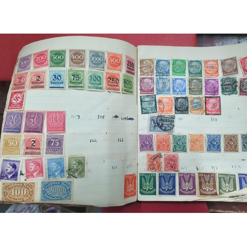 280 - Four stamp albums, the largest (red), half filled with 20thC Hungary, one other with Germany 20thC u... 