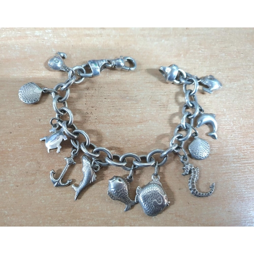 30 - Fine quality Italian 925 silver, heavy charm bracelet with all charms being sea related,

33 grams  ... 