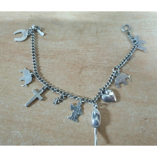 37 - Silver charm bracelet with T-bar fastener,

14 grams              17cm long