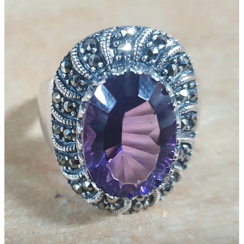 39 - Silver and Marcasite ring with large oval cut Amethyst in presentation box,

size R