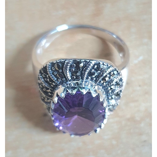 39 - Silver and Marcasite ring with large oval cut Amethyst in presentation box,

size R