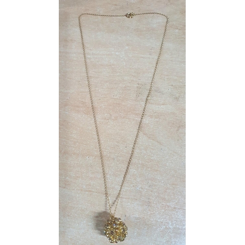 46 - Unusual unmarked yellow gold coloured necklace with gold plastic 3D pendant in presentation box,

7 ... 