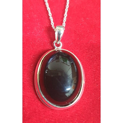 47 - Polished Jet cabochon pendent on a fine silver chain.