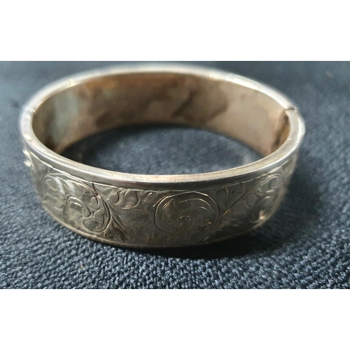 71 - Edwardian silver hinged and engraved bangle,

27.5 grams