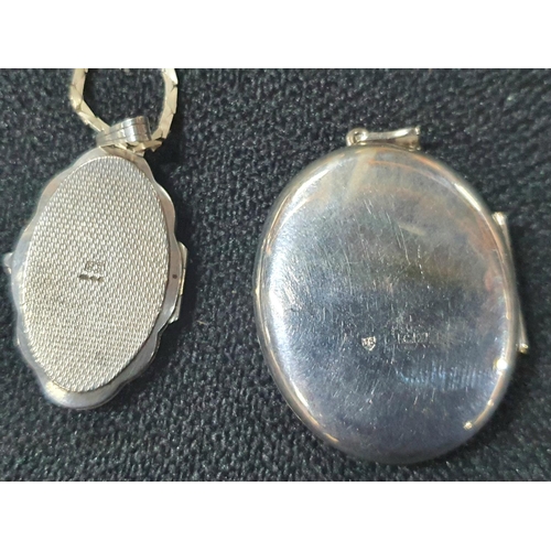 74 - Large silver hallmarked pendant together with a smaller floral engraved silver pendant on a silver c... 