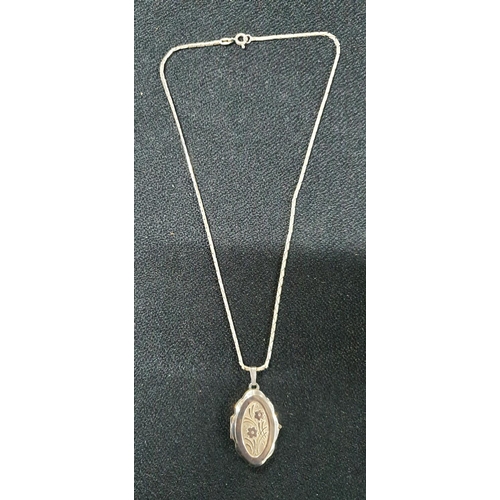 74 - Large silver hallmarked pendant together with a smaller floral engraved silver pendant on a silver c... 