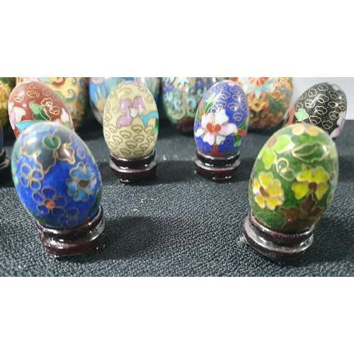 225 - Collection of small enamel eggs, mostly on wooden stands together with 5 larger examples (Qty)