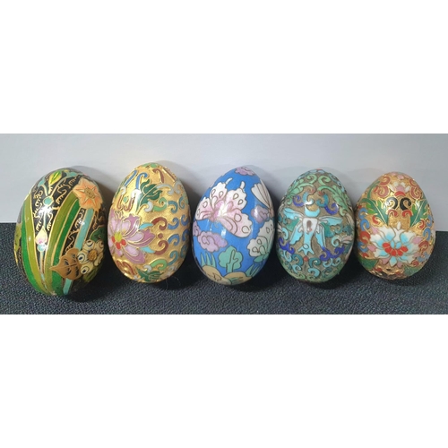 225 - Collection of small enamel eggs, mostly on wooden stands together with 5 larger examples (Qty)