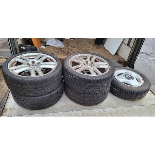 475 - Four Jaguar alloys and tyres together with another (5)