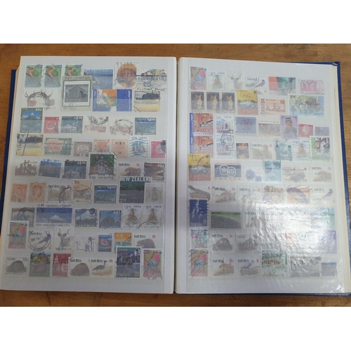 210 - Blue stock book containing a large quantity of world stamps, mainly used (HUndreds)