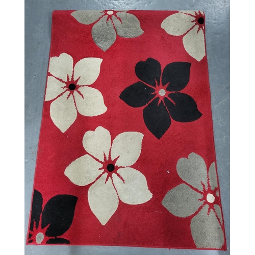 258 - Dark red rug with Black and White Floral patterns, measures 120cm x 163cm