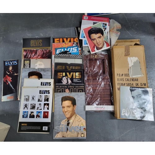 131A - Large quantity of Elvis themed calendars together with a box full of Elvis movies on VHS (Qty)