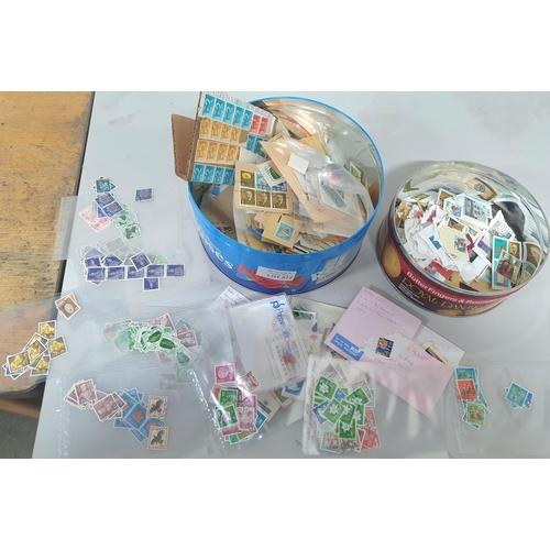 877 - Two tins filled with world stamps, mainly used but some mint including a large quantity of Japan use... 