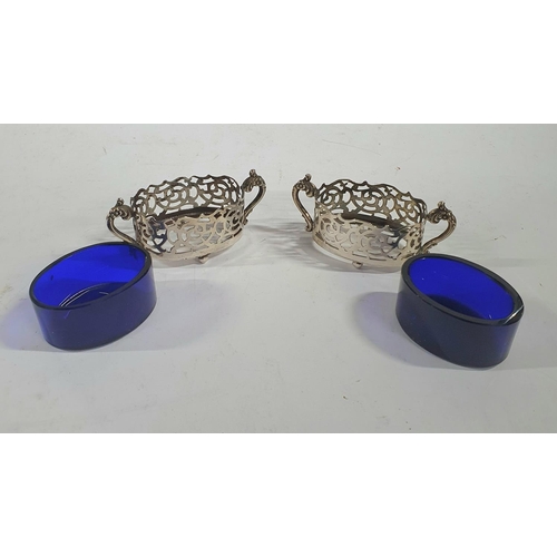 43 - Pair of Birmingham 1924 salts in the form of pierced 2-handled baskets and both with blue glass line... 