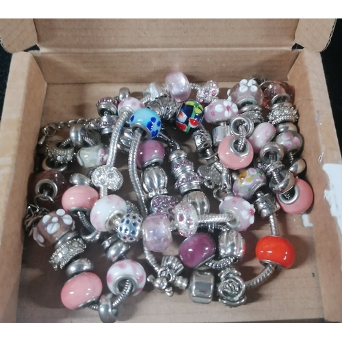 56 - Collection of pandora-style bracelets with charms and beads, some possibly silver (Qty)