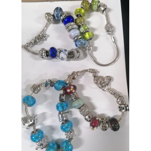 56 - Collection of pandora-style bracelets with charms and beads, some possibly silver (Qty)