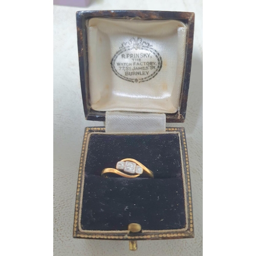 77 - 18ct yellow gold hallmarked ring with a round cut central diamond flanked to either side by a small ... 