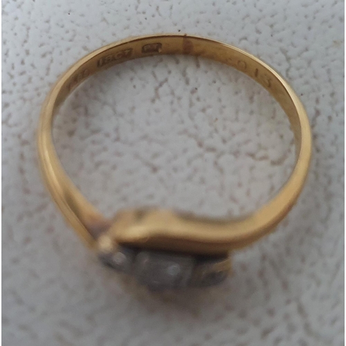 77 - 18ct yellow gold hallmarked ring with a round cut central diamond flanked to either side by a small ... 