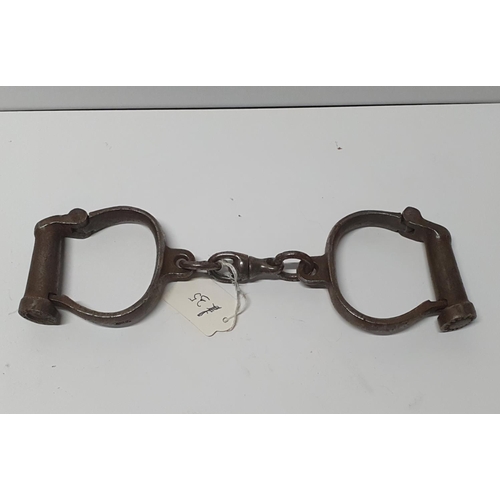 100 - Pair of early 20thC handcuffs, no key