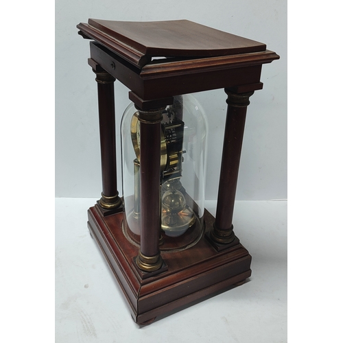 130 - Gustav Becker largem domed clock and pendulum in wood cased surround, with key