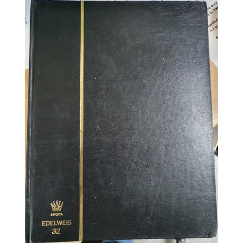 582 - Black Edelweis stamp album containing world stamps, Albania to Jersey, used and mint (Hundreds)