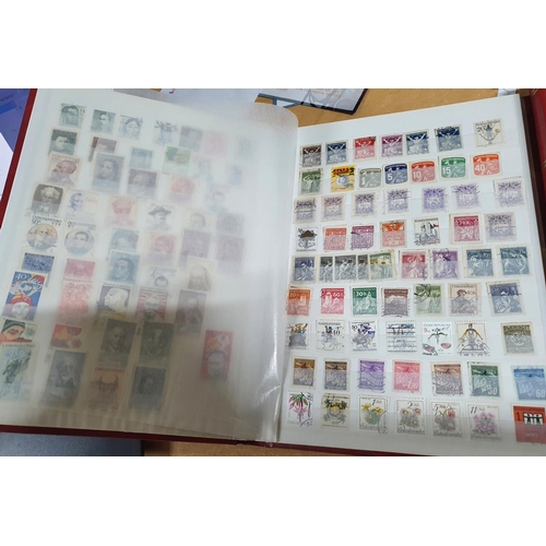 597 - Two red stock albums, one containing a large quantity of used 20thC Czechoslovakia and Sri Lanka, th... 