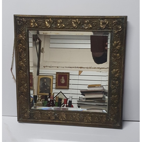 97 - Old small bevel edged mirror with hammered brass fronted frame