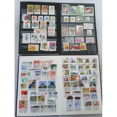 927 - Two small stock books, one containing floral related used stamps from around the world, the other co... 