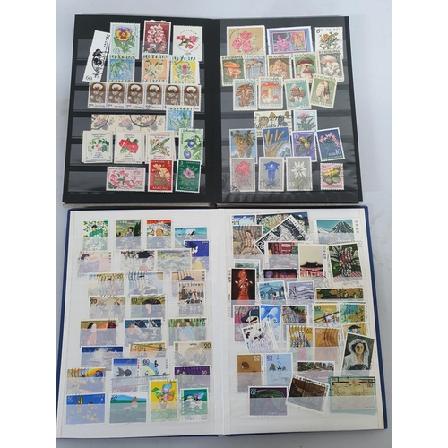 927 - Two small stock books, one containing floral related used stamps from around the world, the other co... 