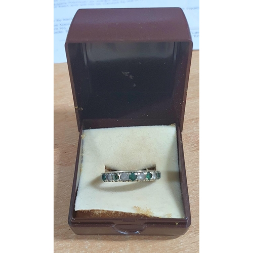 55 - Unmarked white metal eternity ring containing round cut emeralds and other clear semi-precious stone... 