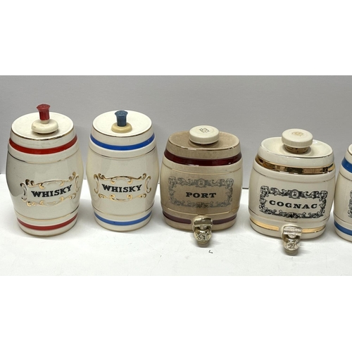 114 - Seven small alcohol barrel dispensers (7)