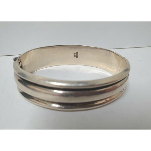 221 - Three heavy hallmarked silver bangles, the 2 engraved bangles both with Birmingham hallmarks, the ot... 