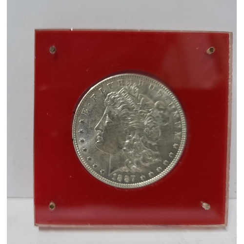 351 - Uncirculated 1887 silver dollar in perspex protective case