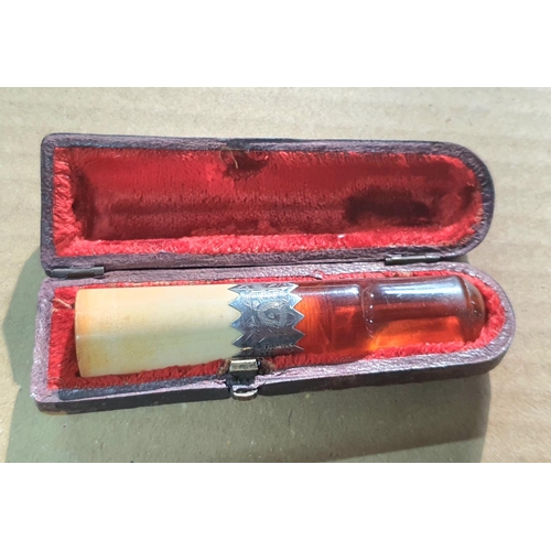 385 - Cased amber cheroot holder with silver banding, Birmingham 1900