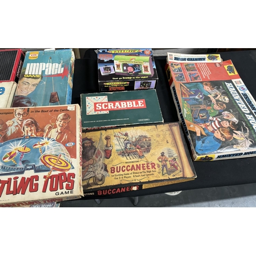 402 - Collection of old games, Haunted house, Battling tops and Possibly one of the first monoploy boards ... 