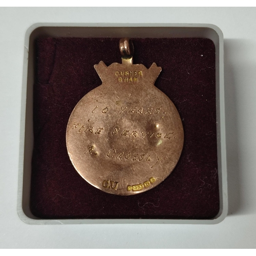 287 - 9ct. Rose Gold, 10 years fire service medal presented to R. Crossly

3.8 grams