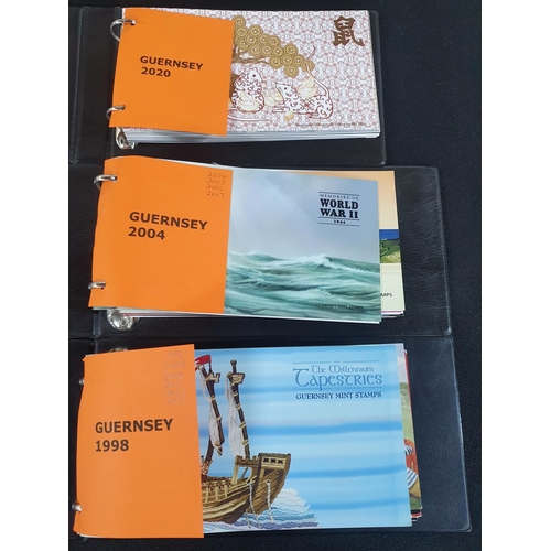 503 - Three official Guernsey albums containing stamp packs for years 1998/9, 2000/1/2/3/4/5/6/7, 2020 (60... 