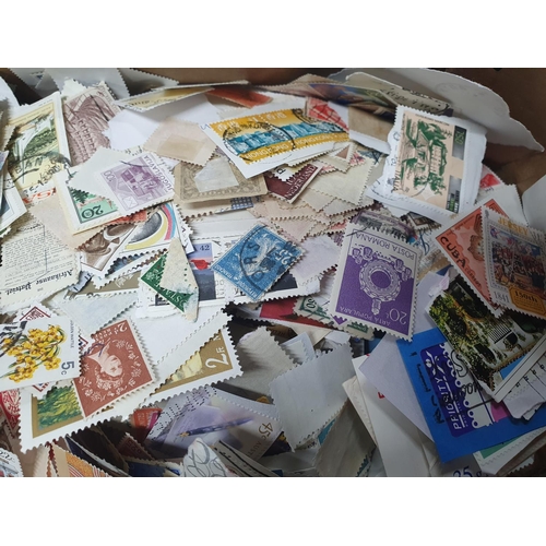 516 - Huge box full of unsorted loose stamps - approx 2.5 kilos