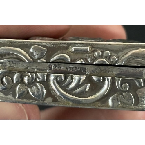 256 - Silver pill box with beaten image depicting a courting couple being serenaded.